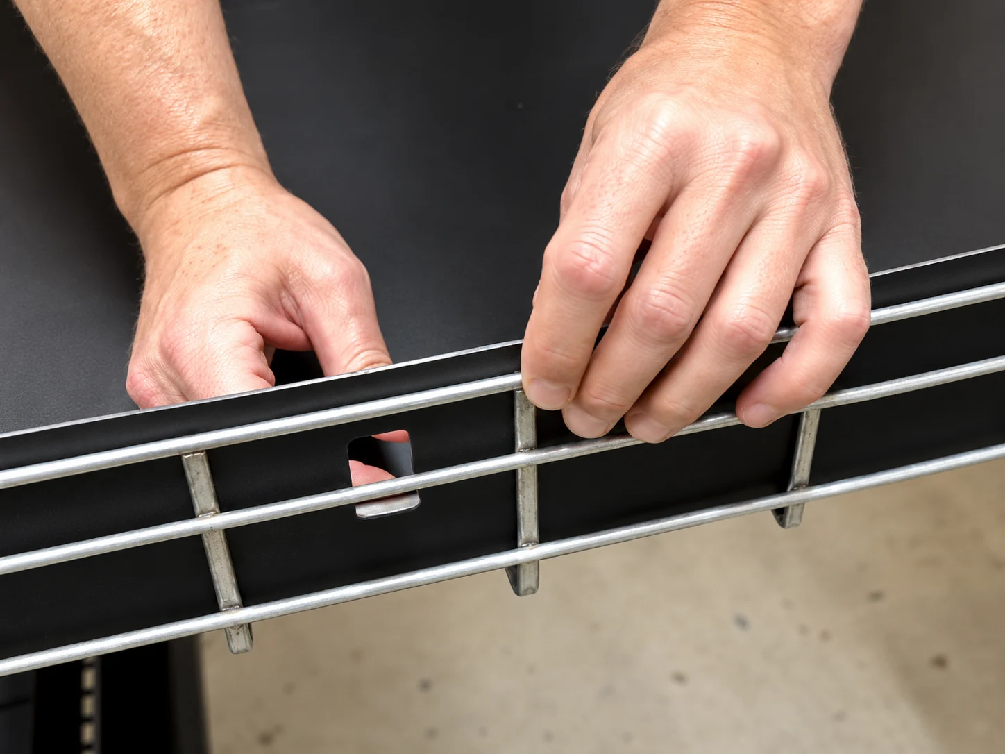 Hands fitting a tool-less tray liner
